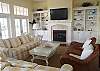 Huge flat screen TV with state of the art sound system, gas fireplace and built in bookcases