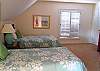 Fourth bedroom with two twin beds, TV and full bath with shower
