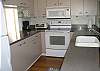 Updated kitchen with Corian countertops, wood flooring and pass thru area to dining