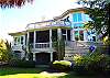 The rear of the house.  Open deck is to the right; large screened porch and open deck on the top level