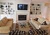 The living room is large and spacious with a large, flat screen TV and plenty of comfortable seating