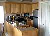 Kitchen has granite tile counter tops and new cabinets. Appliances are brand new!  Kitchen overlooks dining and living area.