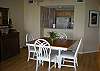 Dining area seats four, hardwood flooring, pass thru to kitchen