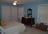 Colorful bedroom accesses screened piazza shares bath with bedroom 2