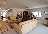 Plenty of comfortable seating in the living room.  There is a formal dining table and a sunroom that leads to the deck overlooking the lagoon