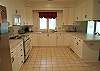 Very large kitchen with plenty of cookware and cabinet space.  Eat in area and desk work space too