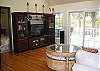 Spacious living area with hardwood flooring and deck access