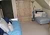 This bedroom has a twin with trundle.  There is a TV and a bonus playroom up a staircase within this bedroom