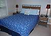 Bedroom features queen bed and bath access