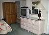 Upstairs bedroom suite view toward the bath area. TV with DVD player