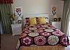This bedroom is on the first level with a queen bed and deck