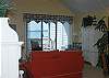 Living room is comfortably furnished with beadboard ceiling