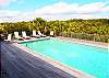 Plenty of outdoor seating and lush landscaping offers a true tropical feel on the pool deck
