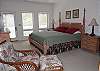 Master suite with king bed, TV, access to deck, and private bath