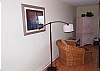 Living area with hardwood flooring, flat screen TV in armoire.