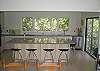 Brand new kitchen with stone counters, stainless appliances, and hardwood flooring. Opens to living room side