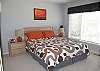Fourth bedroom features a queen bed and private bath