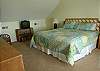 Located upstairs this spacious bedroom offers a king bed, TV and full bath. There is a sitting area outside this room with sleeper sofa and deck
