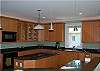 Large gourmet kitchen with custom cabinetry, granite countertops and high end appliances.