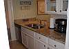 The kitchen is beautifully renovated with granite counter tops, stainless steel appliances and custom cabinets