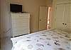 Another view of king bedroom with TV and full bath