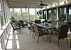 Large screened porch has table for dining and lots of comfortable seating!