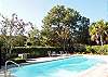 Sun and relax around your private pool surrounded by jasmine covered picket fence
