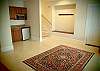 Entrance off the garage, coat rack and wet bar