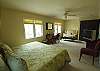 Second master suite with king bed and large sitting area shares bath with queen bedroom