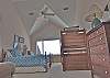 Oceanfront fourth bedroom with two twin beds and a bunk bed.  Sleeps four and has a private bath