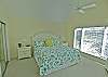 Spacious master bedroom with king bed, vaulted ceiling and TV, private bath