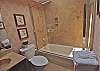 This private bath serves the queen bedroom on the first level of the home