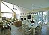 Dining table seats 6, open spacious living area with vaulted ceiling