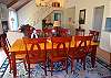 The dining room table seats 8 guests and is convenient to the kitchen