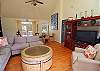Living Room is light, bright with hardwood flooring, vaulted ceiling and large flat screen TV and DVD