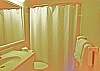 Located on the first level, this bath with tub/shower is shared by the queen bedroom and king bedroom