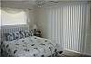 Appointed with a queen bed and deck access this bedroom offers great light