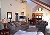 The great room is spacious with vaulted ceilings, lots of comfortable seating and great light. Two sliding glass doors lead to the deck