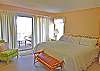Located on the lower level, this bedroom has a king bed, flat screen TV, access to the bath from the bedroom and screened porch