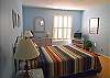 This queen bedroom is located on the first level. Enjoy a spacious room with TV. Share 1.5 baths on this lower floor with the other bedroom