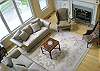 Overhead view of the great room with white oak flooring, fireplace, and built in bookcases.  This is unfurnished.