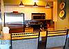 Unique renovation creates a high granite bar with stools for chatting with the chef or light dining