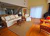 hardwood flooring, deck with grill and dining table that seats 8