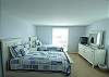 Third bedroom with twin beds, flat screen TV and private bath with shower