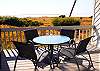 Enjoy ocean views and salty breezes from the deck.  There are two additional chairs not pictured.