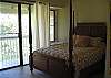 Main level master bedroom.  Lanai overlooking the golf course.  Ceiling fan.