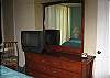 TV in bedroom, window a/c and ceiling fan.