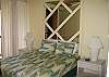 Queen size bed.  Window a/c and ceiling fan.