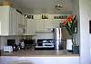 Newer kitchen cabinetry with tile counter tops.