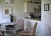 Dinging table with 4 chairs overlooking front lawn/garden area.